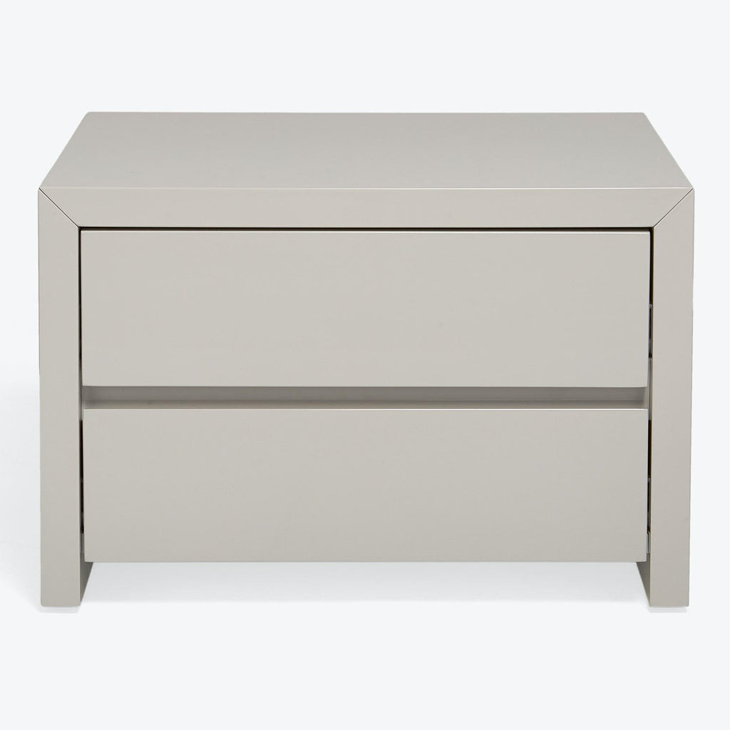 Modern minimalist nightstand in soft neutral tone with seamless drawers.
