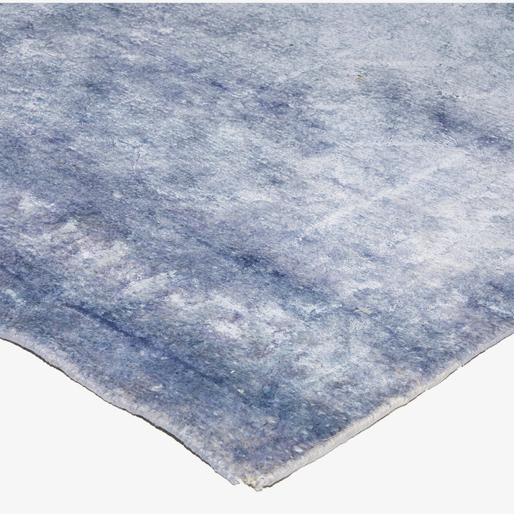 Luxurious blue carpet with a cloud-like pattern adds modern elegance.