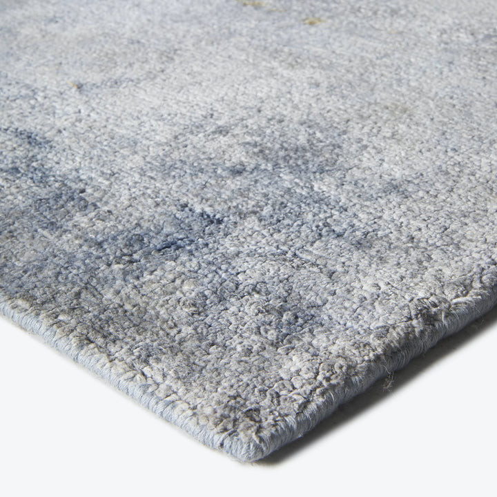Close-up of a soft, plush grey carpet with shaggy texture.