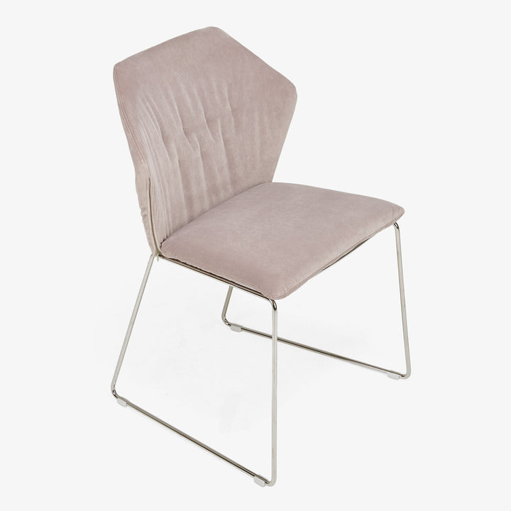 Modern chair with cantilever base, pink upholstery, sleek minimalist design.