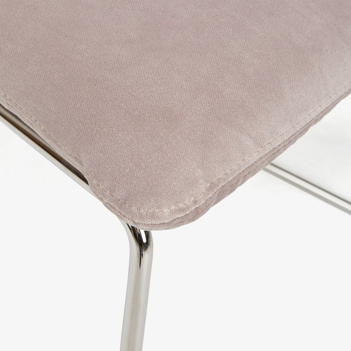 Modern beige fabric cushioned furniture with metallic frame, stylish design.