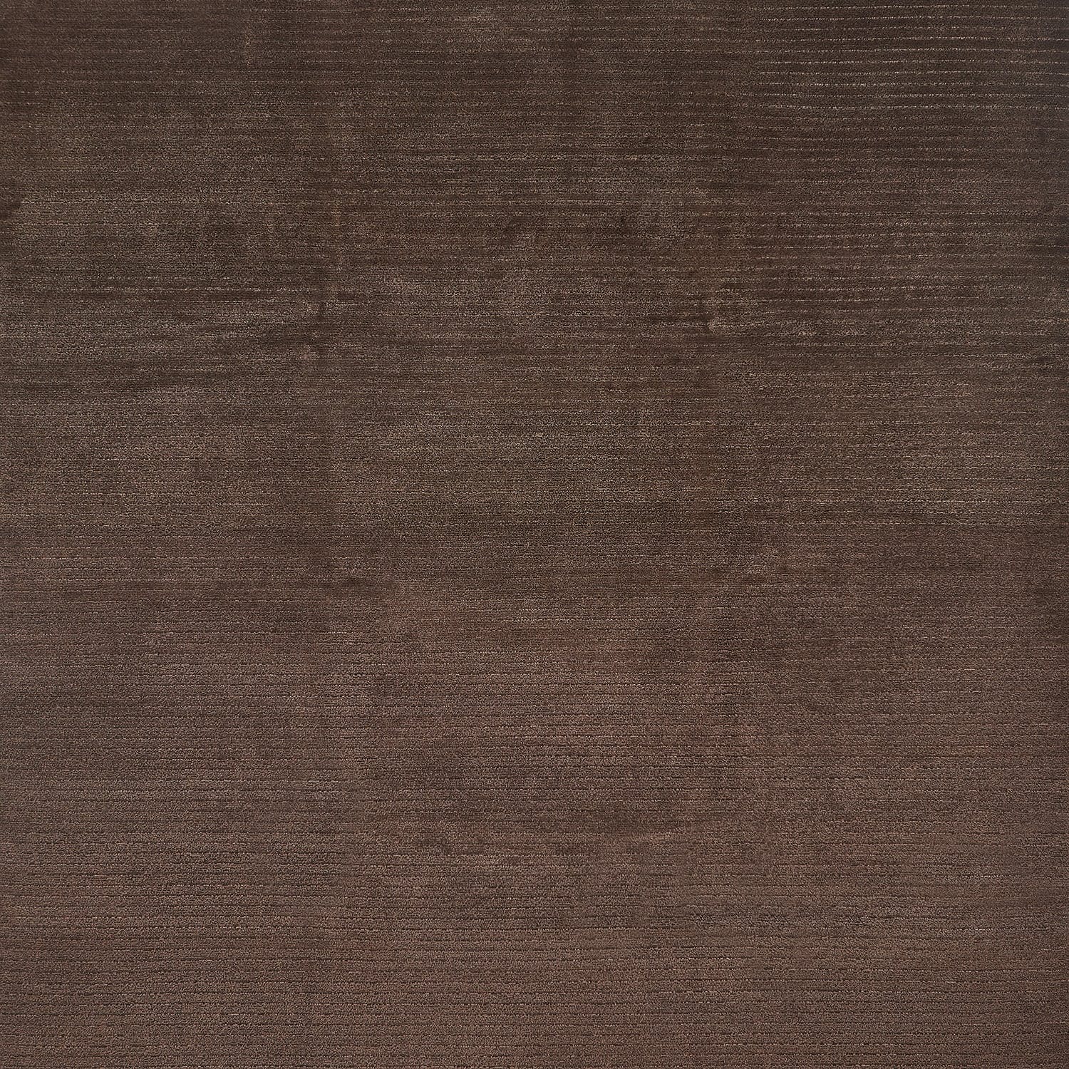 Close-up of a deep brown, textured fabric with subtle variations.