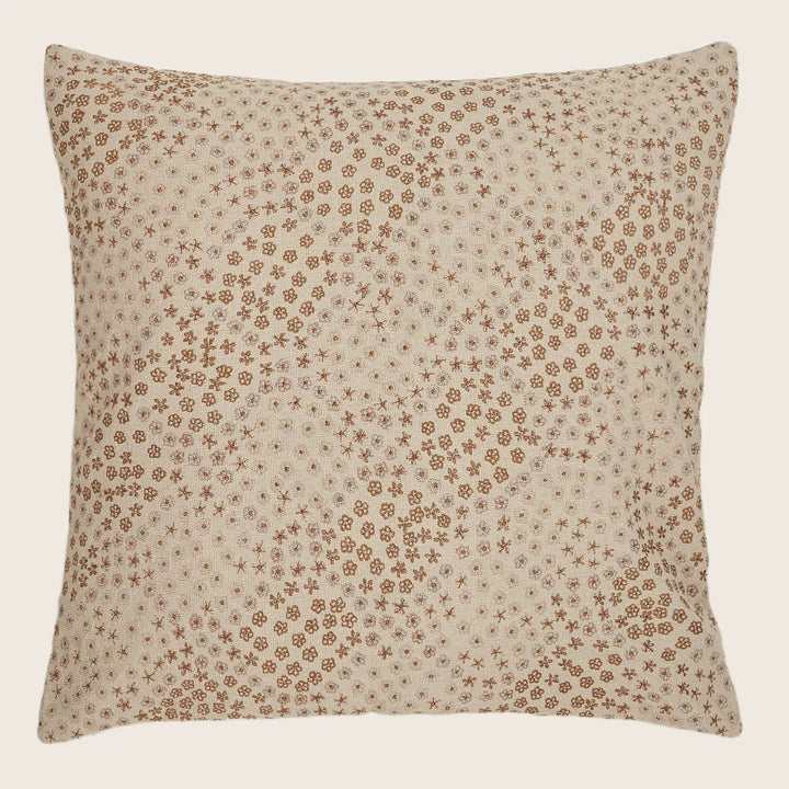 Square-shaped pillow with rustic floral pattern adds charm to décor.