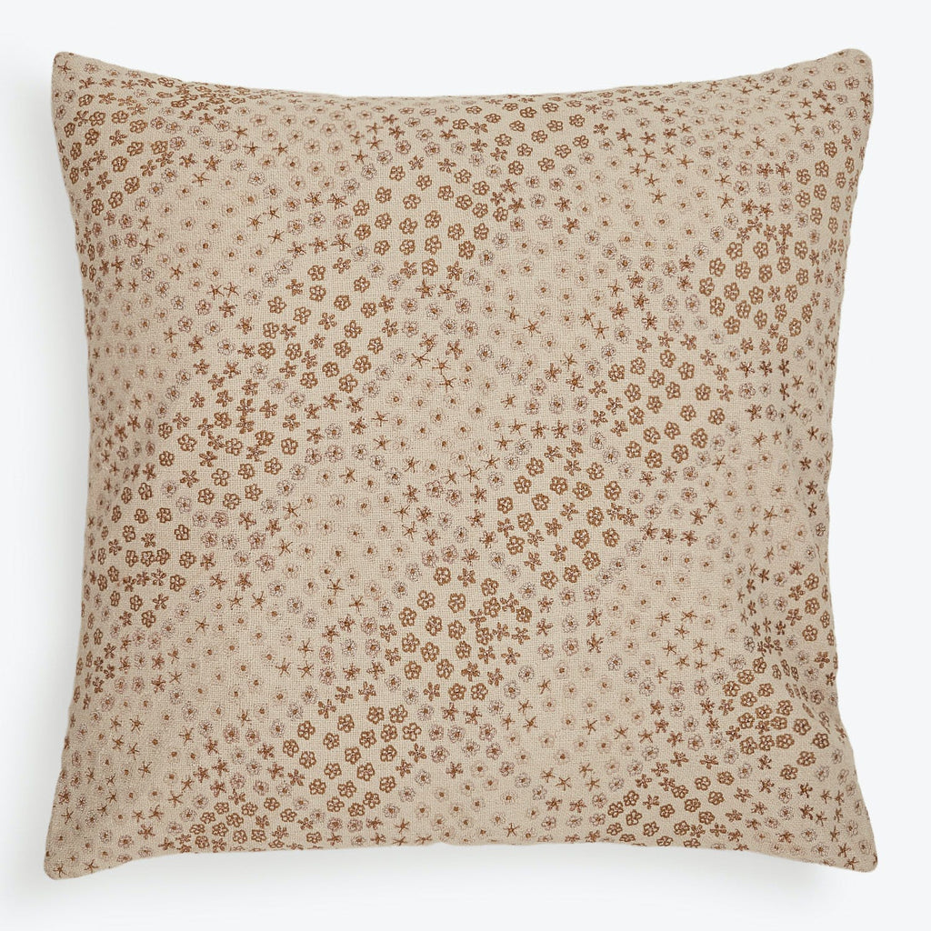 Square-shaped pillow with rustic floral pattern adds charm to décor.