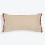 Rectangular beige pillow with burgundy fringe on a white background.