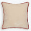 Square velvet pillow with beige tone and reddish-brown trim.