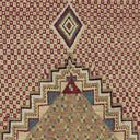 Close-up of a handmade textile with geometric patterns in vibrant colors.