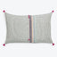 Decorative woven cushion with textured design, featuring asymmetrical stripe detail.