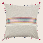 Bohemian throw pillow with textured fabric, colorful stripes, and tassels.