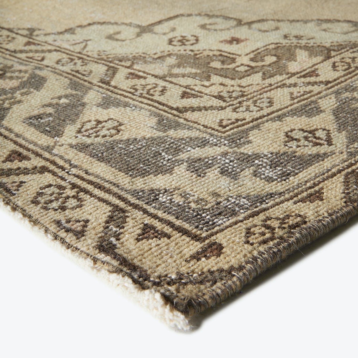 Close-up of a traditional area rug with floral and geometric motifs.