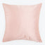 Plain light pink pillow with smooth texture and fluffy appearance.