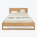 Neatly designed wooden bed with minimalist aesthetic and decorative elements.