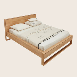 Neatly designed wooden bed with minimalist aesthetic and decorative elements. - hover