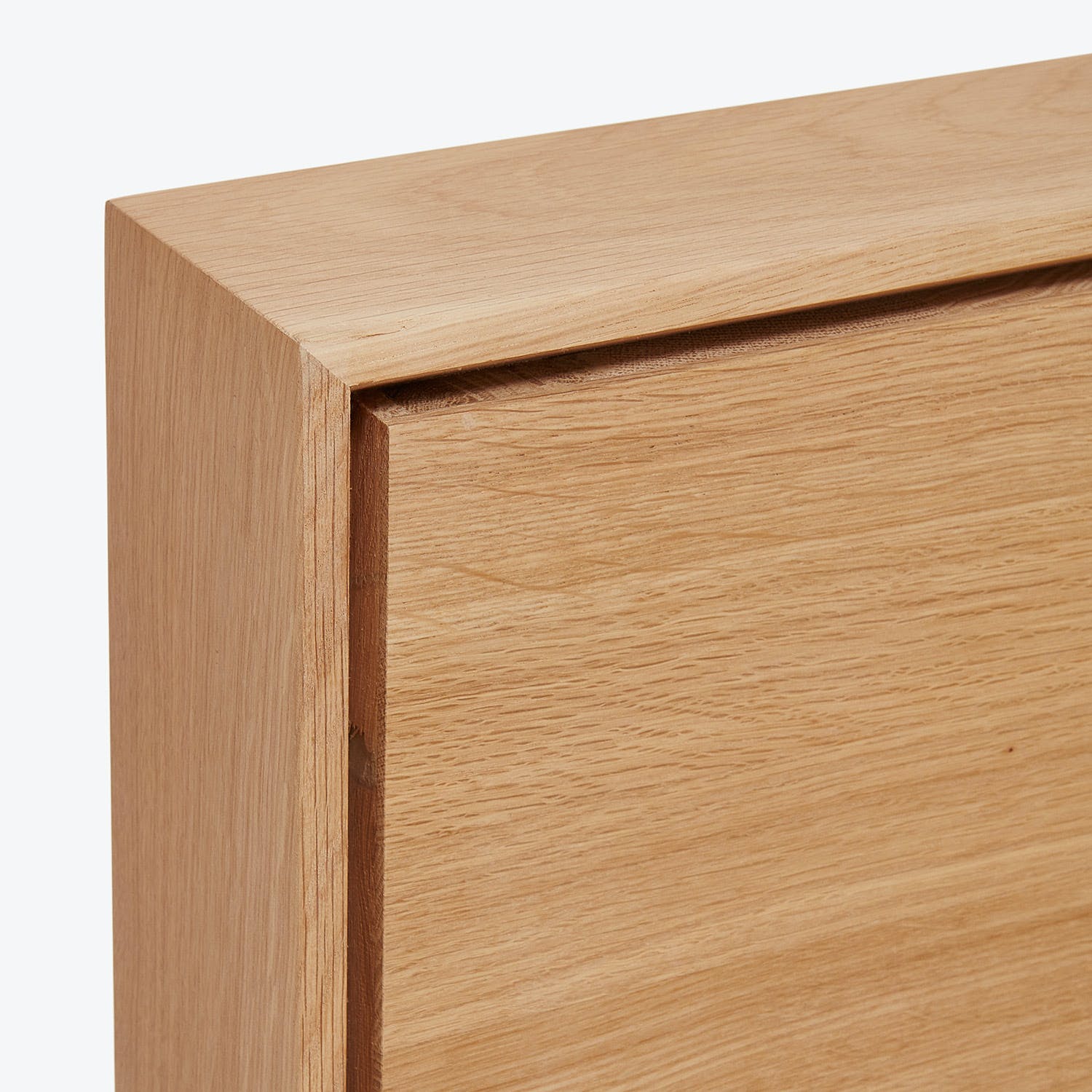 Expertly crafted oak corner joint showcases clean minimalist design aesthetic.