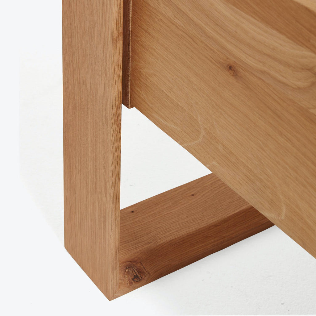 Close-up of a wooden furniture piece with smooth finish and knots.