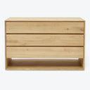 Minimalist wooden dresser with clean lines and light wood finish.