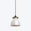 Antique brass pendant light with frosted glass shade and textured surface.