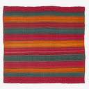 Handcrafted rustic textile with vibrant multi-colored stripes and worn edges.