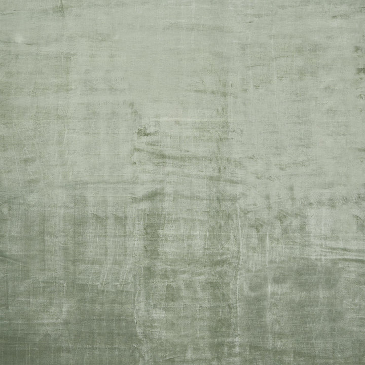 Close-up of pale green, textured fabric with visible weave pattern.