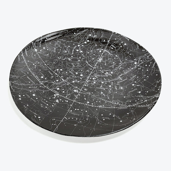 Decorative round object features detailed star map with constellation illustrations.