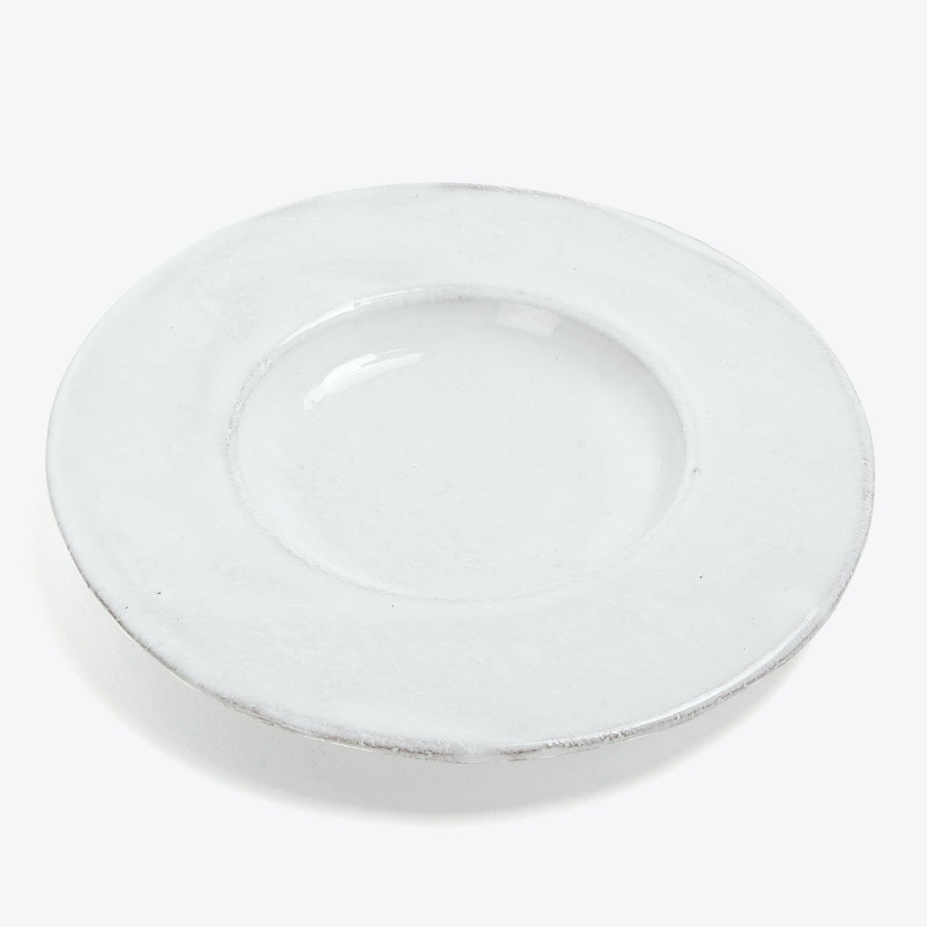 A plain white plate with slight wear, suitable for dining.