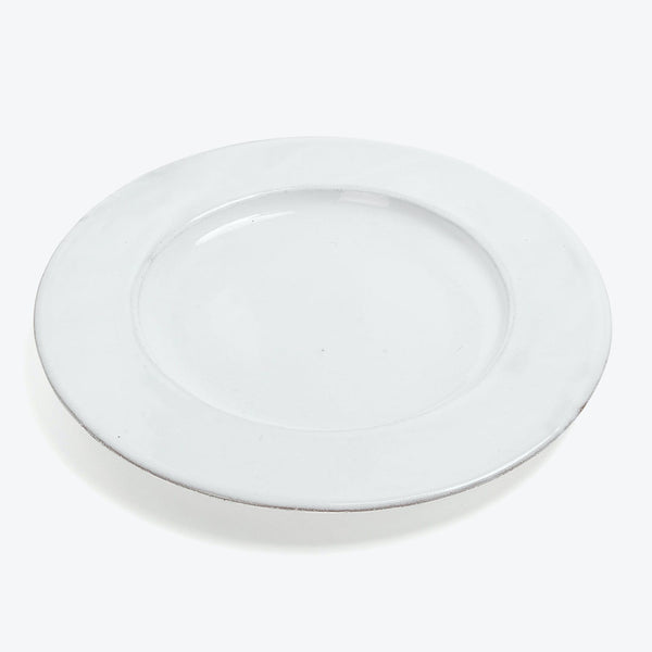 Minimalist white plate with a subtle raised edge and center depression.