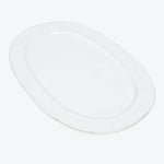 Minimalist white plate with a glossy finish reflecting light.