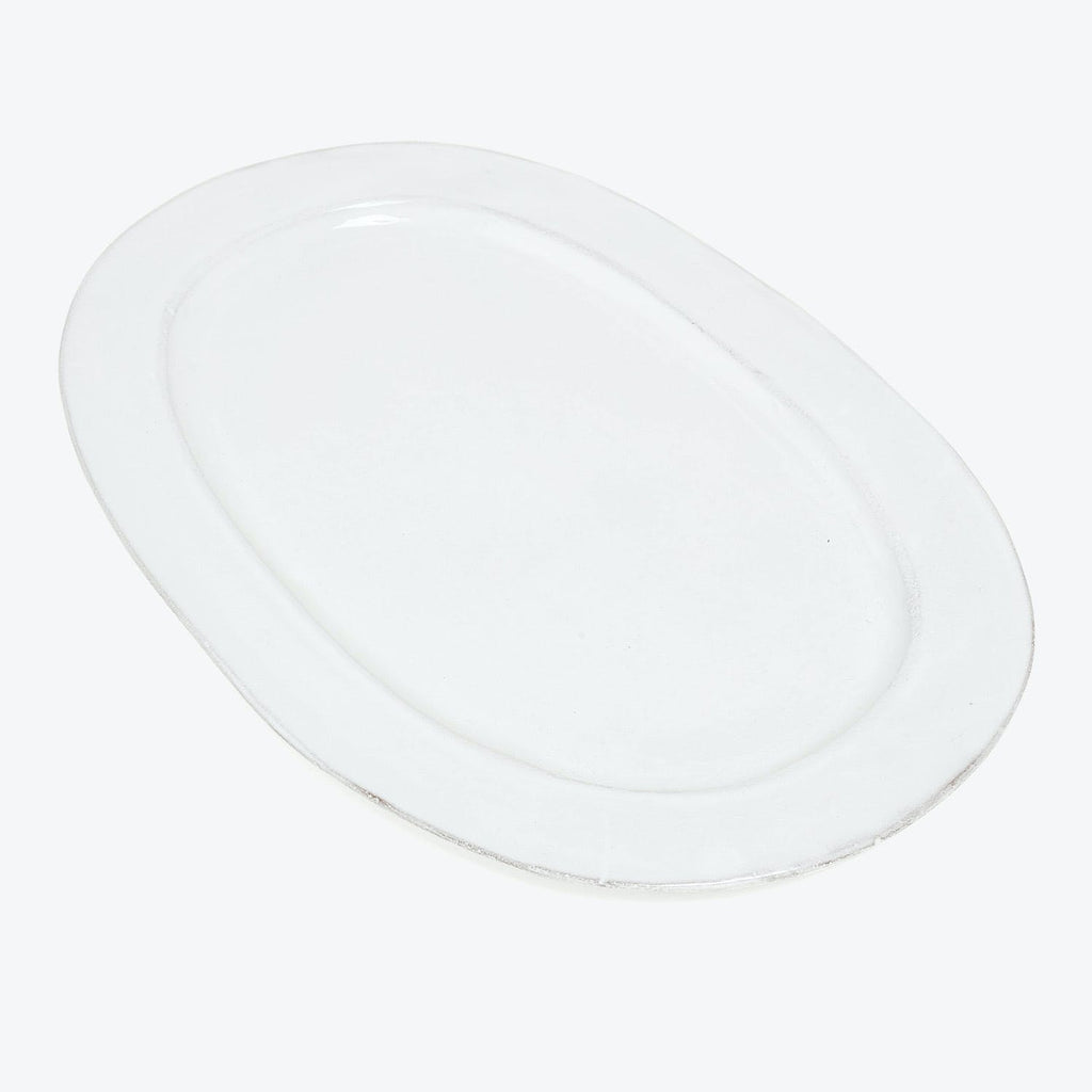 Minimalist white plate with a glossy finish reflecting light.
