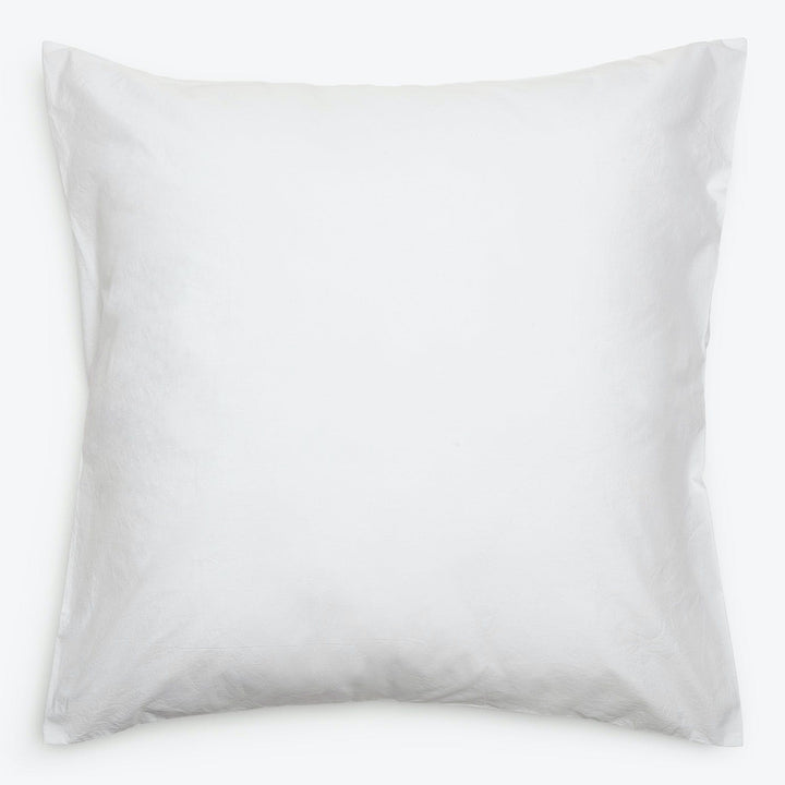 Plain white pillow with a smooth surface and rounded edges.