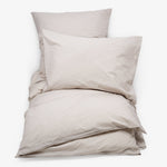 Neutral and cozy bedding set in soft, off-white tones.