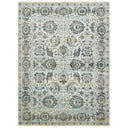 Intricately patterned ornate rug with muted vintage color palette.
