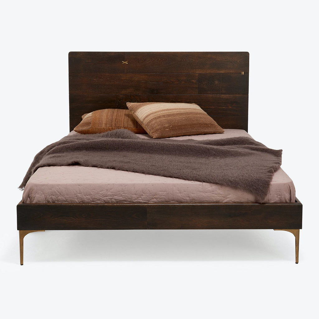 Fashionable modern-style bed with dark wood finish and elegant brass inlay details