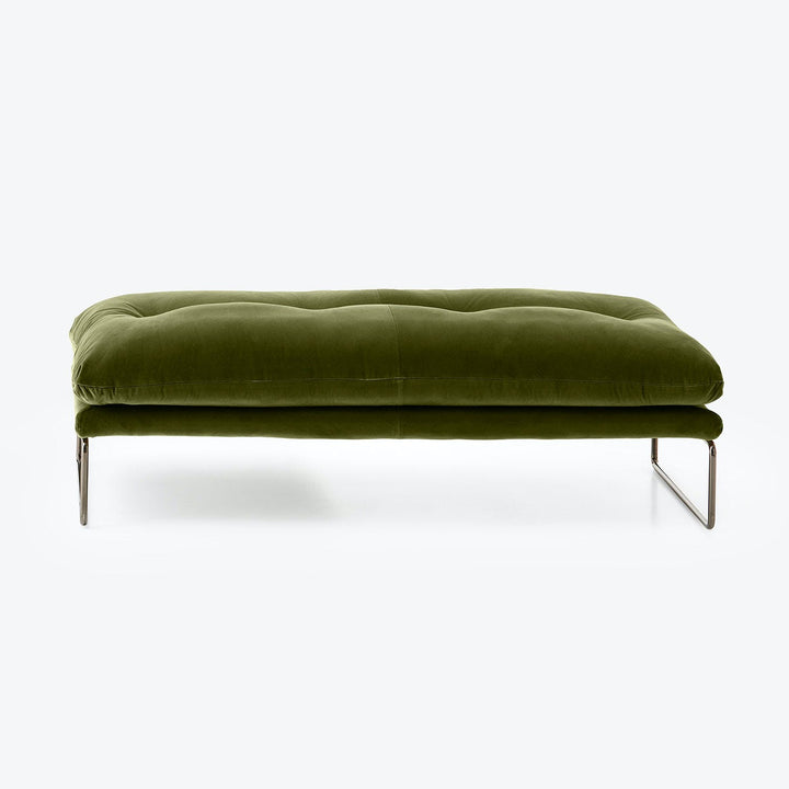 Modern, minimalist ottoman in green velvet with sleek steel base.