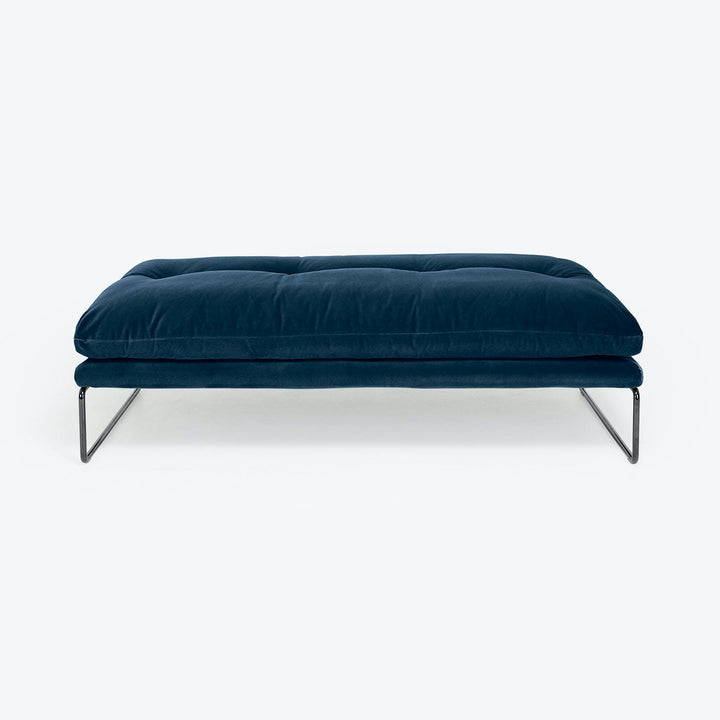 Modern deep blue velvet ottoman with sleek metal frame design