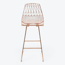 Modern bar stool with copper finish and geometric wire-frame design.