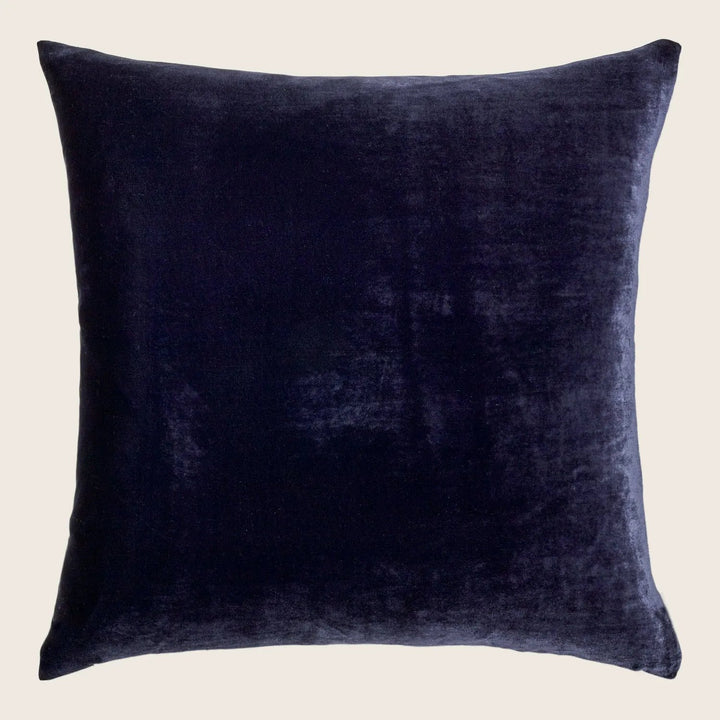 Plush velvet pillow exudes luxury with its dark hue.