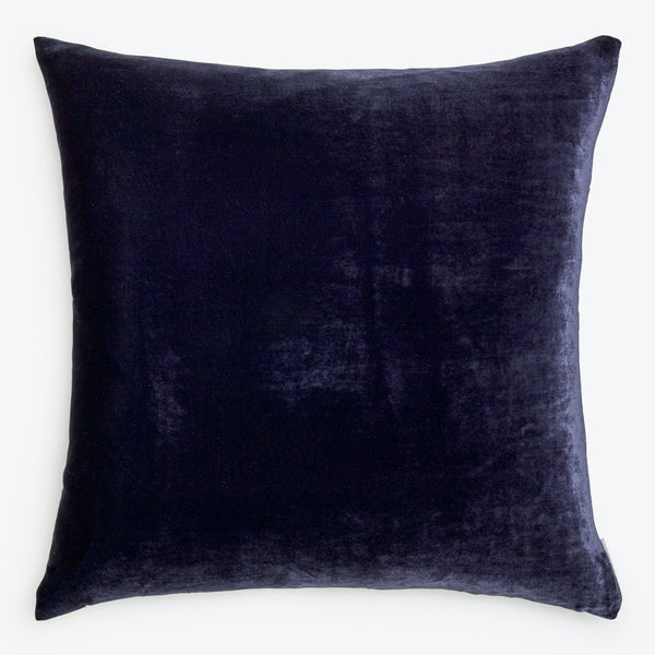 Plush velvet pillow exudes luxury with its dark hue.