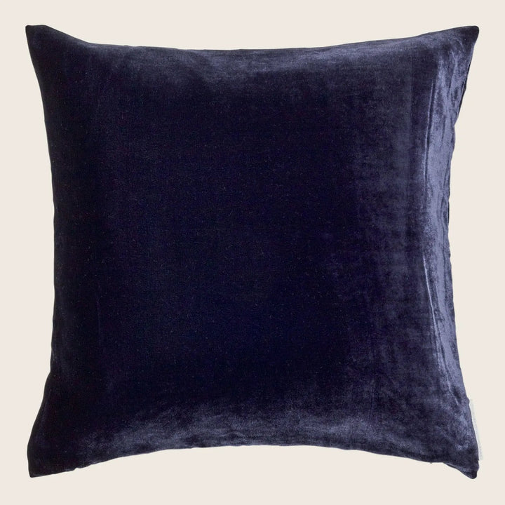 Dark square plush pillow with a luxurious velvety texture.