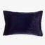 Rectangular velvet-like pillow in dark color with visible tag.