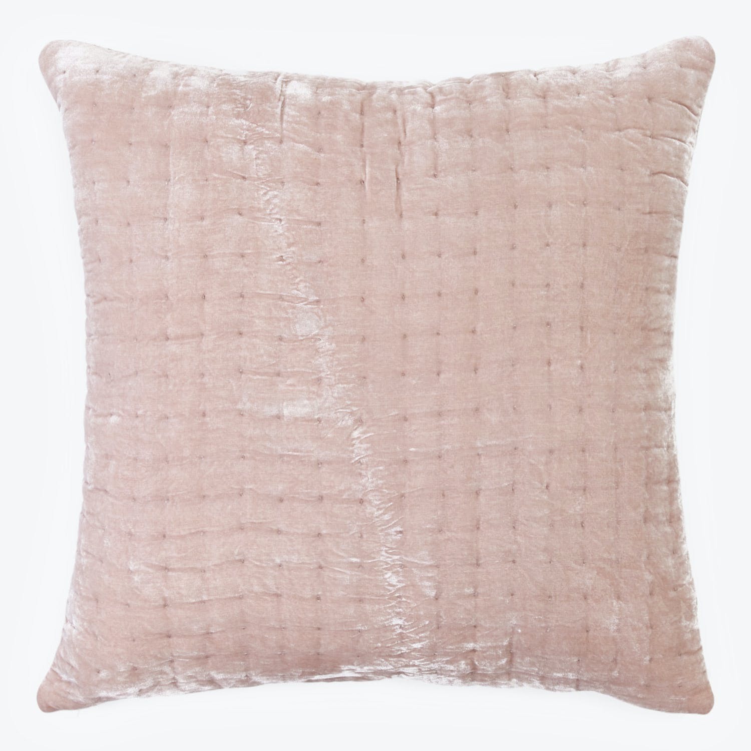 Soft pink velvet pillow with textured surface adds sophisticated charm.