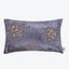 Stylish rectangular pillow with purple hue and splatter design.