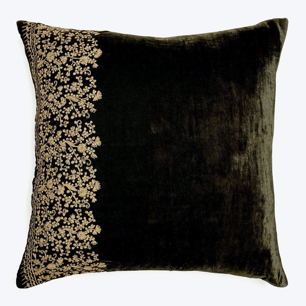 Luxurious black velvet pillow with intricate gold embroidered pattern.