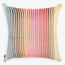 Square decorative pillow with colorful striped pattern and tassels.