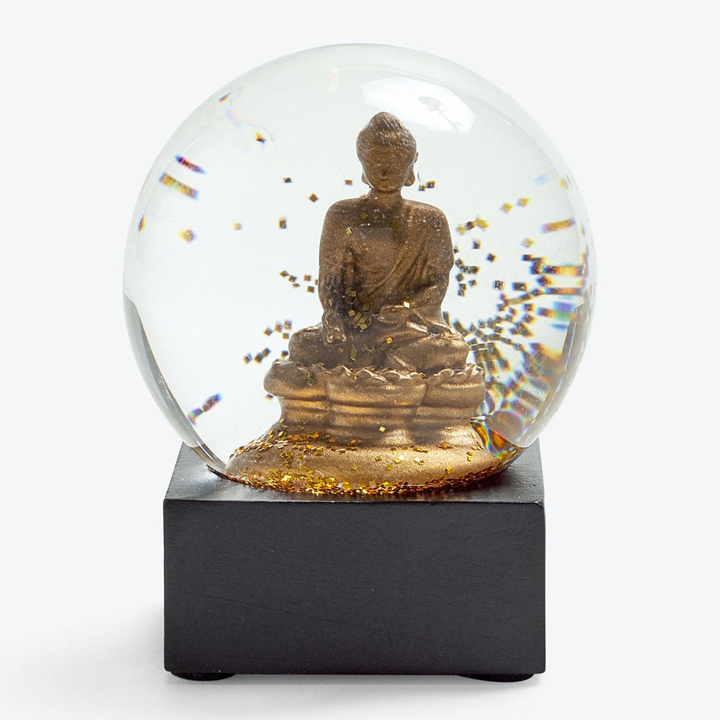 Snow globe featuring a seated Buddha in meditative pose