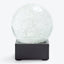 Modern and minimalist snow globe with shimmering glitter particles.