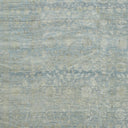 Vintage-inspired fabric with distressed motifs in faded blue and cream.