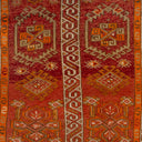 Intricate geometric design of traditional handwoven rug in warm colors.