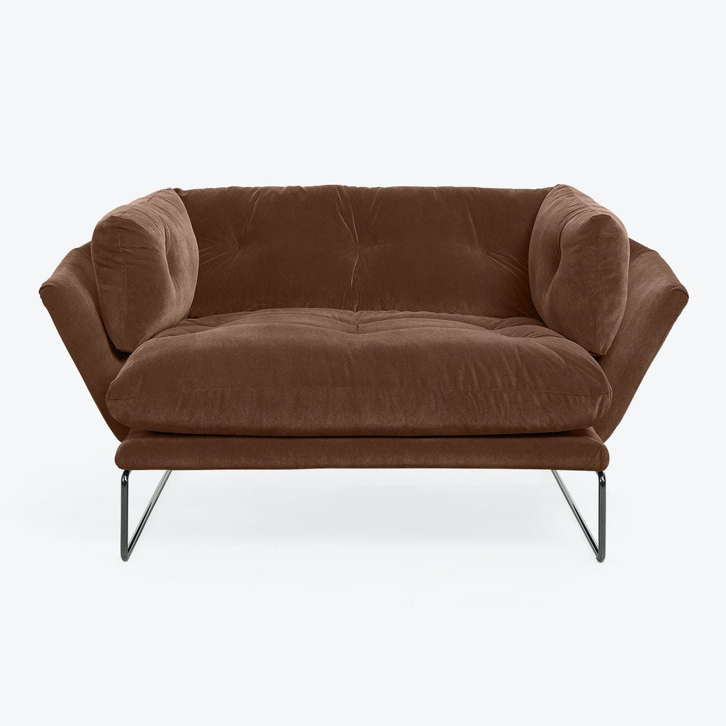 Modern-style sofa with plush brown upholstery and tufted cushions.