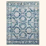 Vintage-style rectangular area rug with ornate blue symmetrical design.