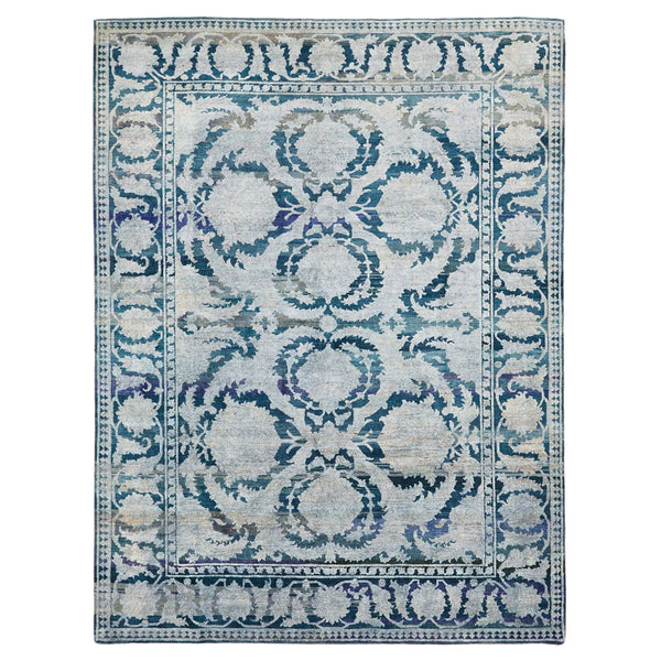 Vintage-style rectangular area rug with ornate blue symmetrical design.